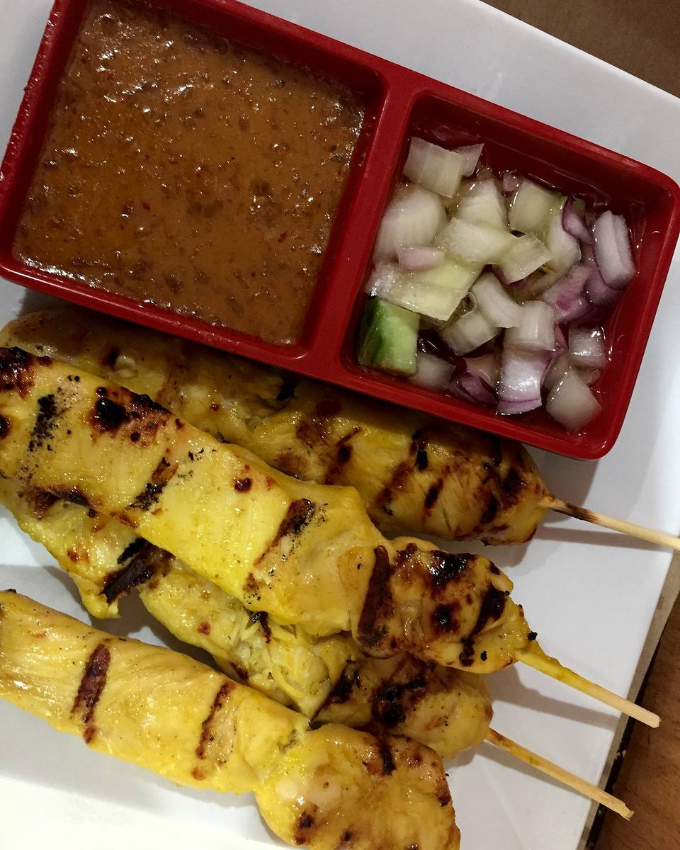 Grilled chicken satay skewers with peanut sauce and cucumber relish.