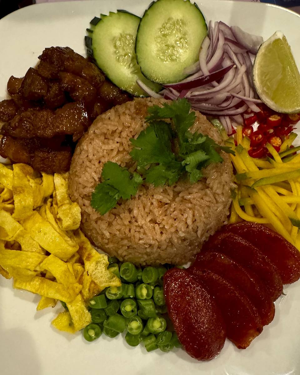 Shrimp-paste fried rice with sweet pork, egg strips, green mango, shallot and chili, with cucumber and lime.